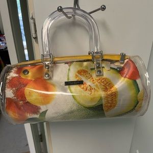 Preowned copy Kate Spade plastic covered purse with bakelite handles.